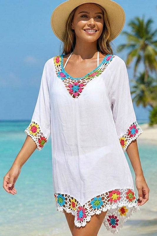 Sierra CEO of Berrydog Bikinis modeling a Crochet Cover-Up with a thong bikini visible underneath the Cover-up while standing on the sand at a Tropical Beach.