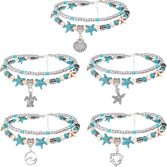 Set of five beaded bracelets with starfish and shell charms on a white background