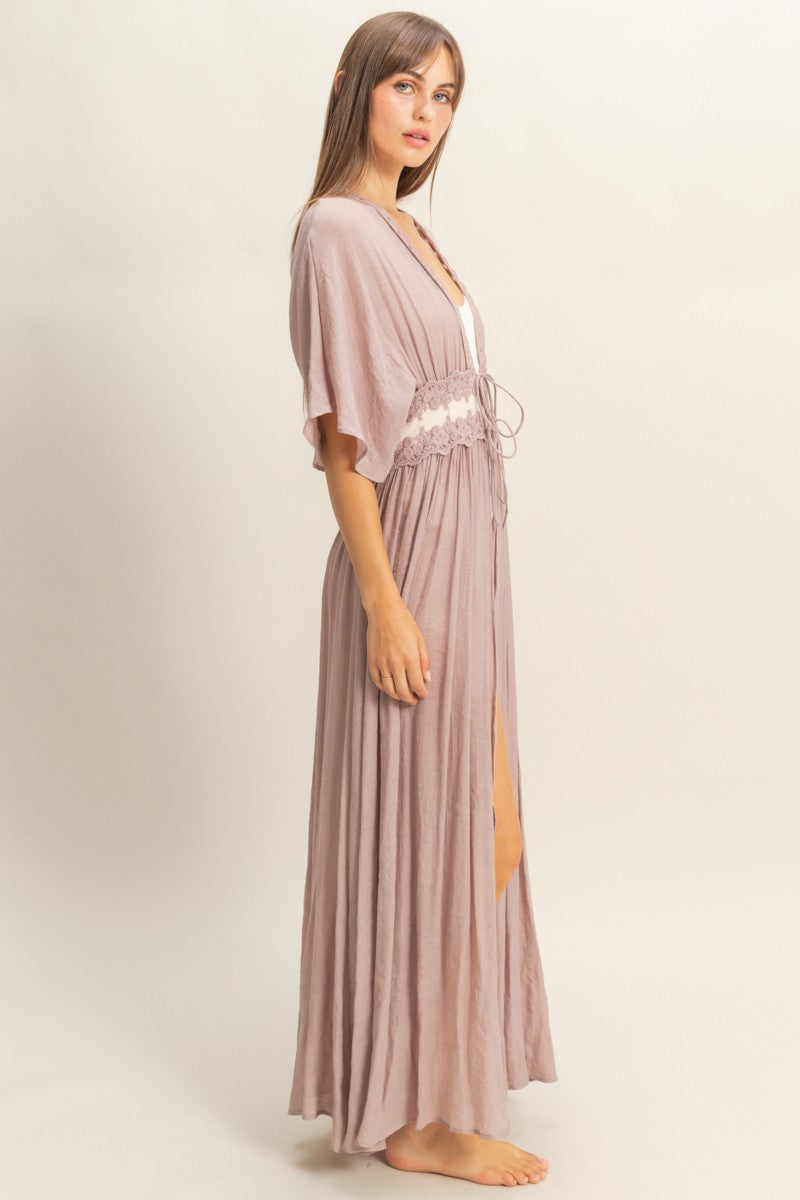 Woman wearing a long, light brown / mauve robe / beach coverup. On Sale 